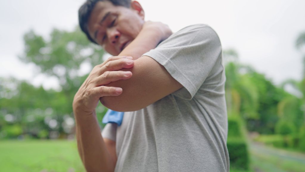 asian-active-middle-aged-man-having-a-sudden-elbow-pains-or-joint-pain-after-hard-work-SBI