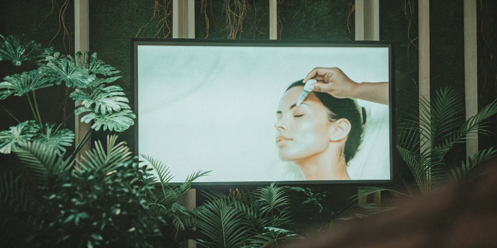 Woman receiving MSC exosome therapy for skin tightening with a serum applied by a dropper.