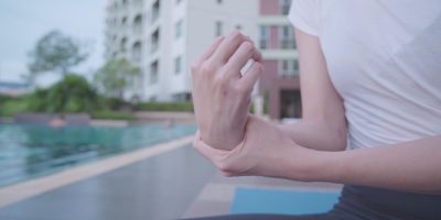 close-up-woman-feel-hurt-having-wrist-and-hand-pain-touching-and-massaging-on-the-wris-SBI-351074393