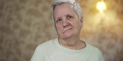 elderly-woman-with-facial-paralysis-SBI-350053890