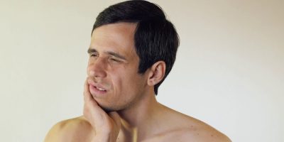young-man-having-a-toothache-SBI-350915859